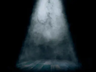 Spotlight over a dark, empty stage.